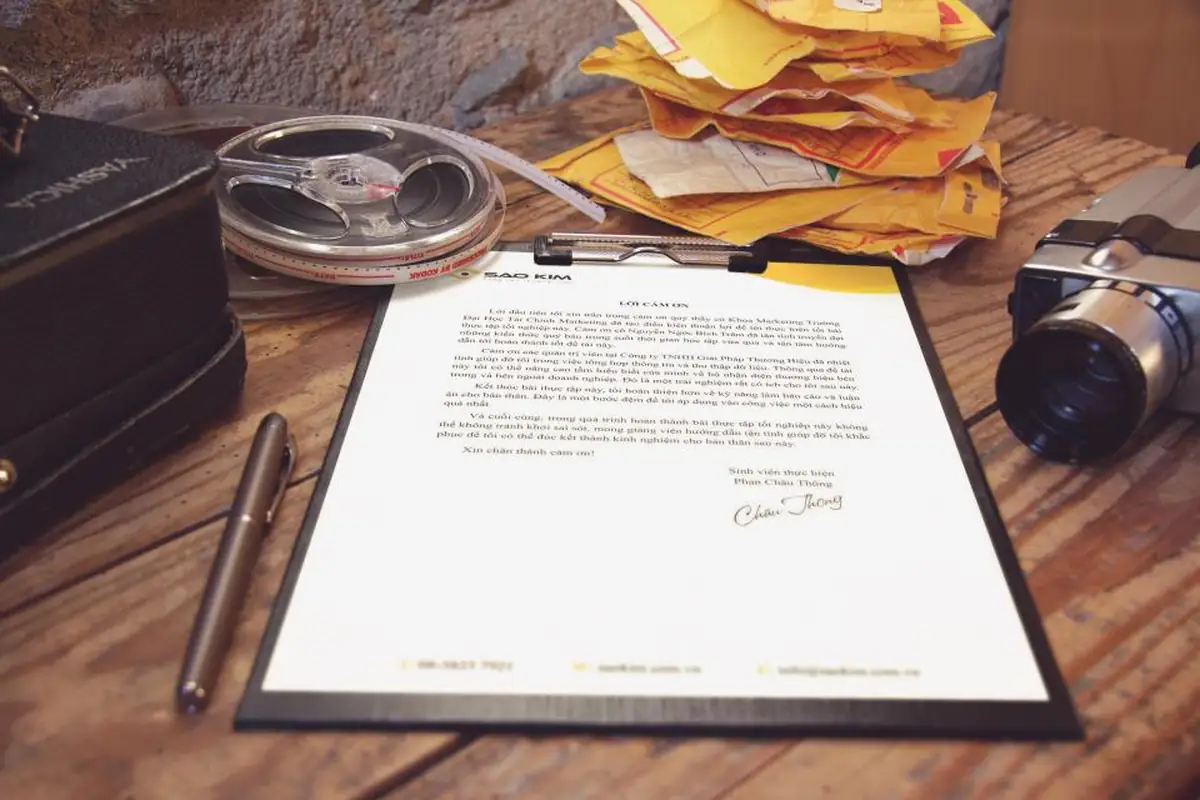 A signed document with a pen and a magnifying glass