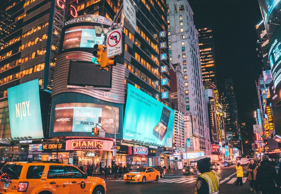 Pedestrians crossing a busy street between tall city buildings