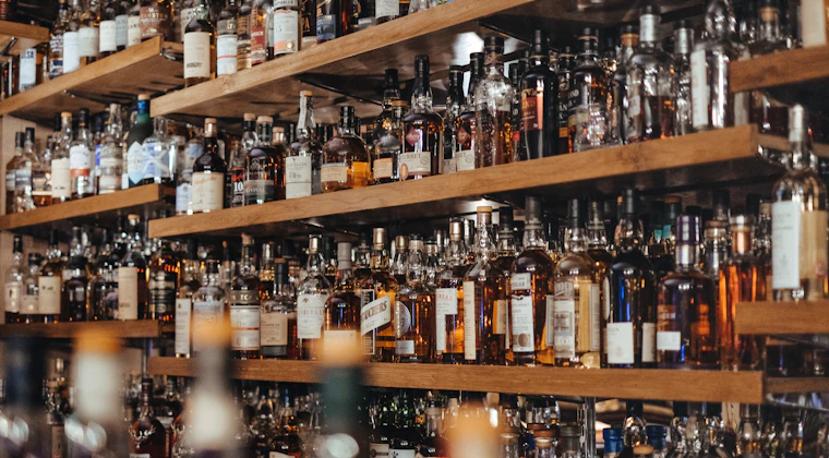 Bottles of spirits arranged on a bar shelf