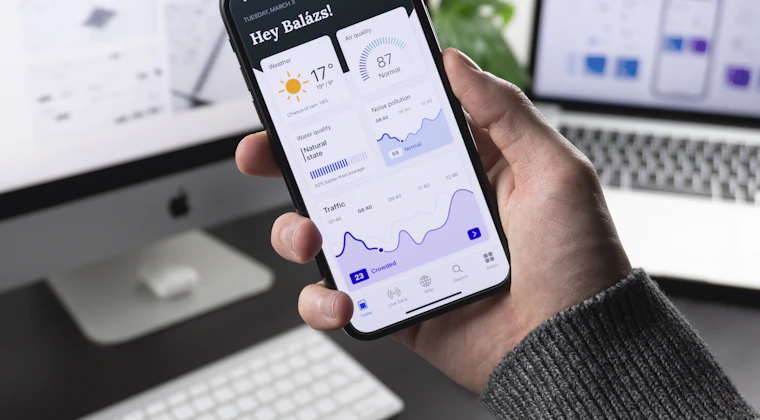 A smartphone showing a finance application on a desk