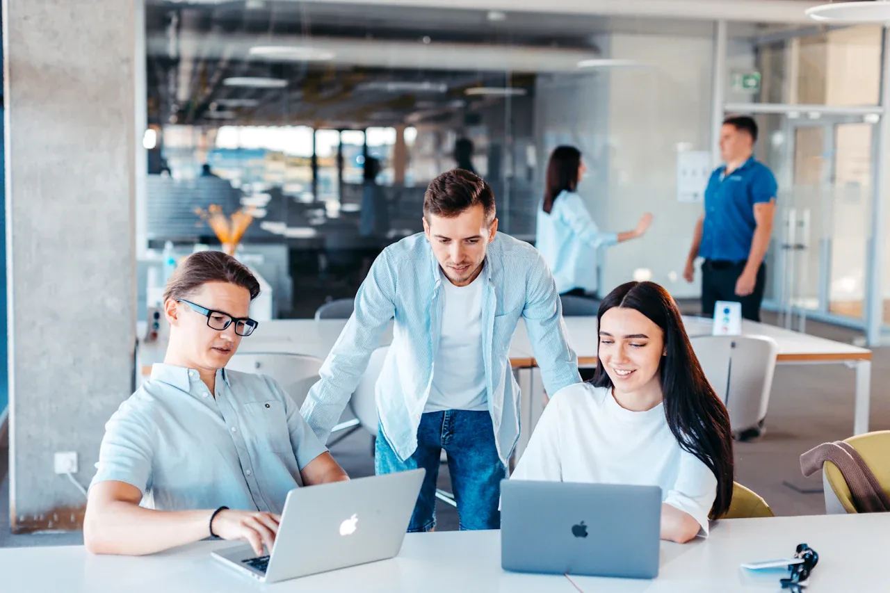 Team working together on laptops in an open-plan office