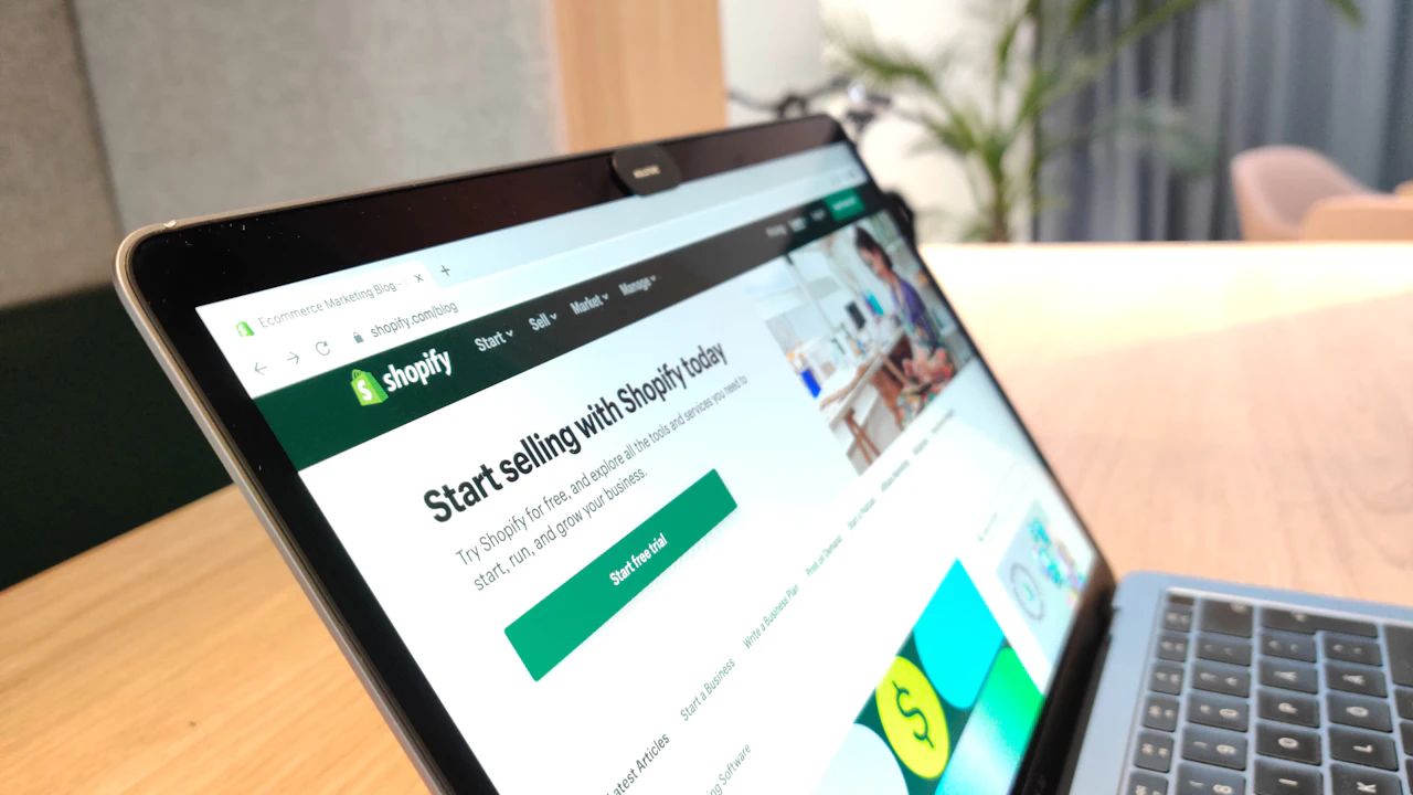 Laptop on a desk displaying an e-commerce platform homepage