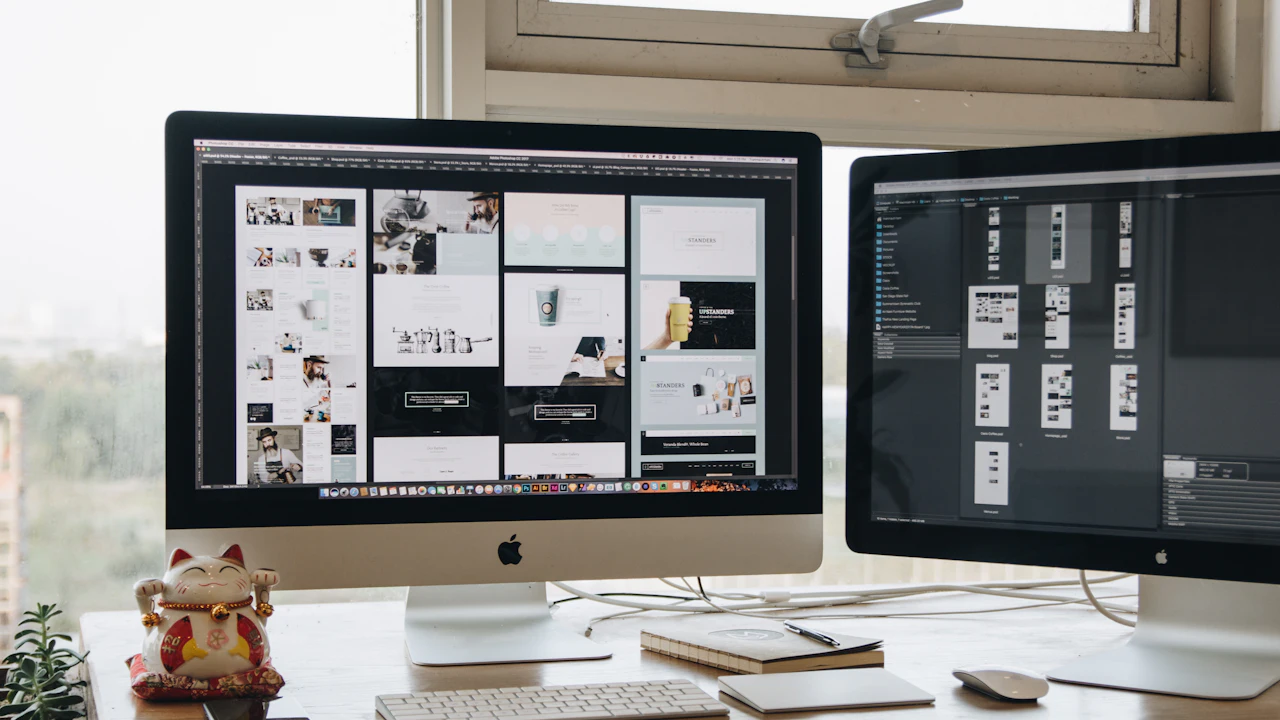 Two monitors showing website page layouts side by side